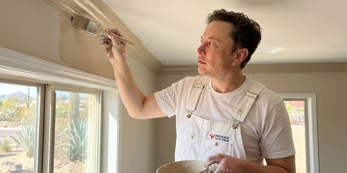 Interior painter carefully applying wall paint with brush near ceiling trim in Phoenix Arizona home showing attention to detail and professional technique